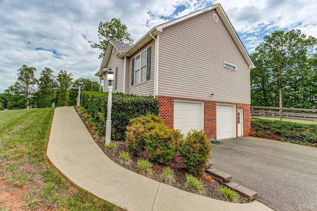 22 Semmes Ct, Rustburg, VA 24588 - view of home's exterior featuring a garage, driveway, and brick siding