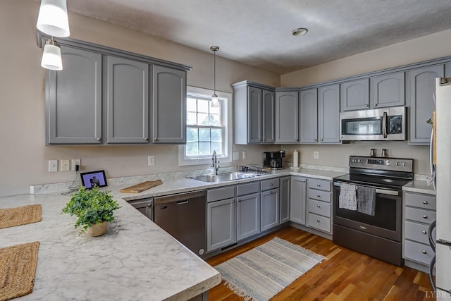 22 Semmes Ct, Rustburg, VA 24588 - kitchen featuring stainless steel appliances, a sink, gray cabinets, dark wood-type flooring, and light countertops