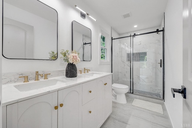 bathroom with marble finish flooring, toilet, a marble finish shower, double vanity, and recessed lighting