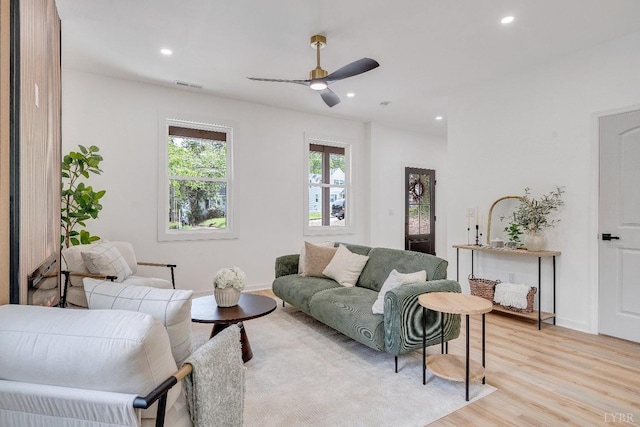 living area with light wood finished floors, recessed lighting, ceiling fan, and baseboards