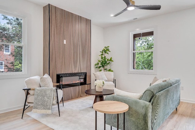 sitting room with wood finished floors, plenty of natural light, and recessed lighting