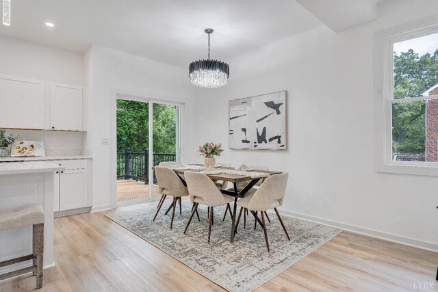 dining room with light wood-style floors, a chandelier, baseboards, and recessed lighting