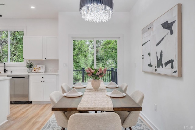 dining room featuring light wood-style flooring, a chandelier, and recessed lighting