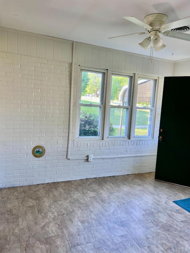 202 Dalton St, Gretna, VA 24557 - unfurnished room with brick wall and a ceiling fan