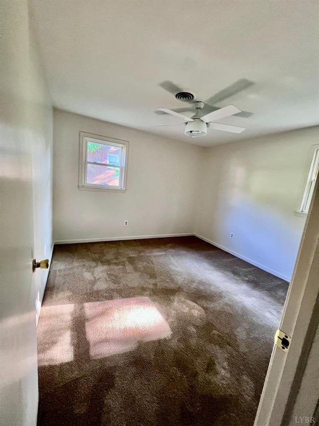 202 Dalton St, Gretna, VA 24557 - empty room with dark carpet, a ceiling fan, and baseboards