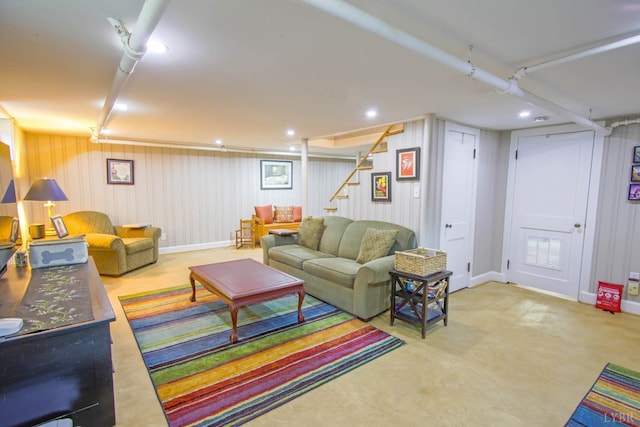 living room with stairs and baseboards