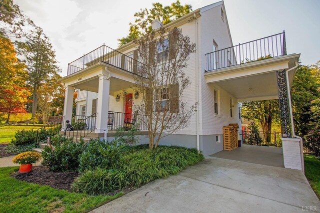 3845 Peakland Pl, Lynchburg, VA 24503 - view of front of house featuring a balcony, covered porch, driveway, and a carport
