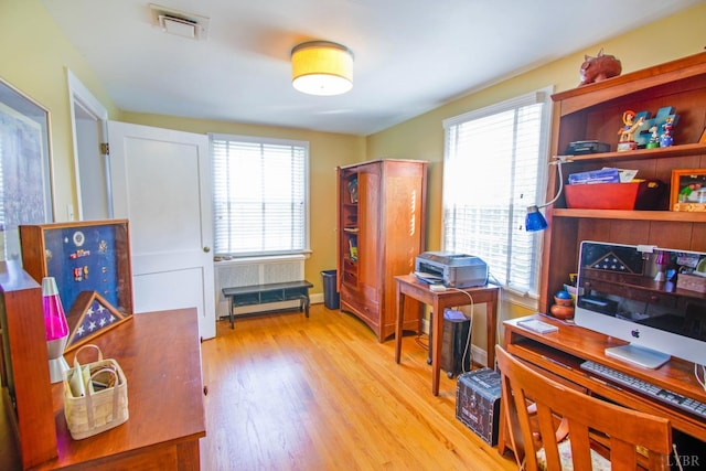 home office with light wood finished floors and plenty of natural light