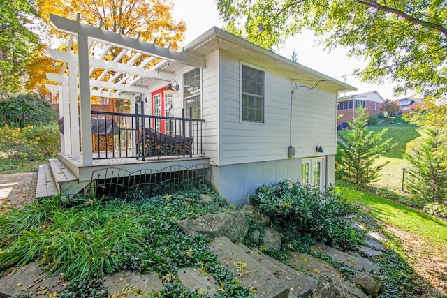 rear view of house featuring a pergola and a deck
