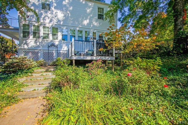 back of property featuring a wooden deck