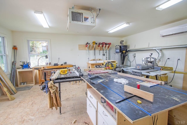 garage featuring a wall mounted AC, a workshop area, and a heating unit