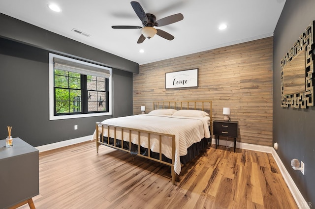 1228 Mill Dam Ln, Forest, VA 24551 - bedroom with wood walls, an accent wall, baseboards, recessed lighting, and light wood finished floors