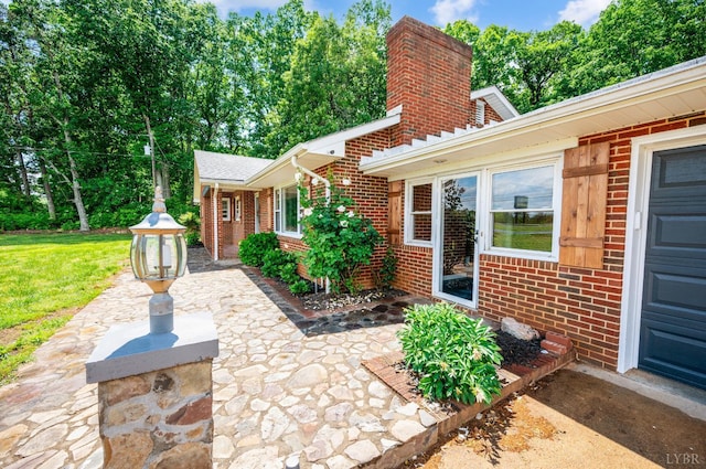 7230 Wards Rd, Rustburg, VA 24588 - view of front of house with brick siding, a patio area, a chimney, and a front yard