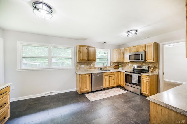 7230 Wards Rd, Rustburg, VA 24588 - kitchen featuring appliances with stainless steel finishes, a sink, backsplash, and baseboards