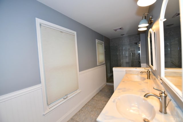 2130 Burnt Bridge Rd, Lynchburg, VA 24503 - full bathroom with double vanity, wainscoting, a tile shower, tile patterned flooring, and a decorative wall