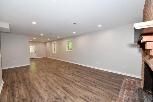 2130 Burnt Bridge Rd, Lynchburg, VA 24503 - unfurnished living room with a brick fireplace, dark wood-style floors, plenty of natural light, baseboards, and recessed lighting