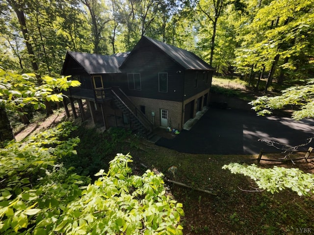 2130 Burnt Bridge Rd, Lynchburg, VA 24503 - rear view of property with stairs, an attached garage, and asphalt driveway