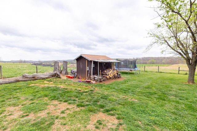 4100 Roark Mill Rd, Hurt, VA 24563 - view of grassy yard with a trampoline, a rural view, and a storage unit