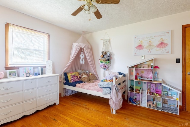 4100 Roark Mill Rd, Hurt, VA 24563 - bedroom featuring light wood-type flooring, a textured ceiling, and ceiling fan