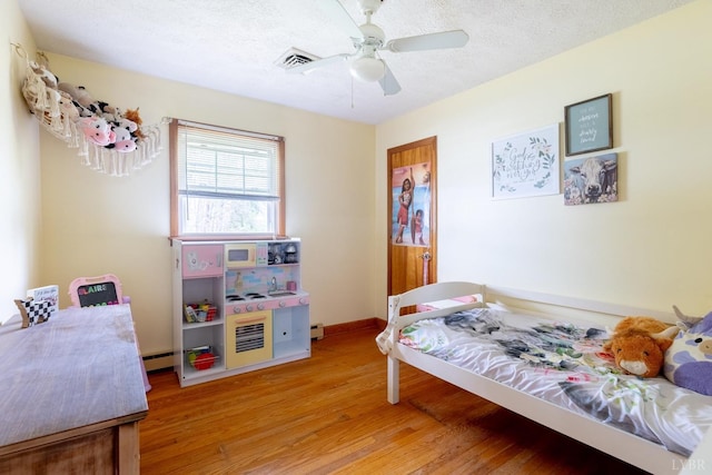 4100 Roark Mill Rd, Hurt, VA 24563 - bedroom with light wood-type flooring, ceiling fan, and a textured ceiling