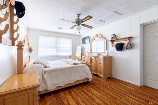 4100 Roark Mill Rd, Hurt, VA 24563 - bedroom featuring attic access, wood finished floors, a textured ceiling, and ceiling fan