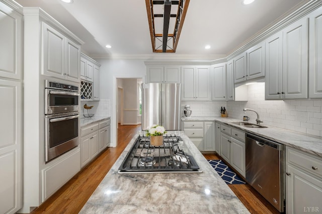 1068 Huckleberry Ln, Lynchburg, VA 24503 - kitchen with stainless steel appliances, a sink, crown molding, wood finished floors, and decorative backsplash