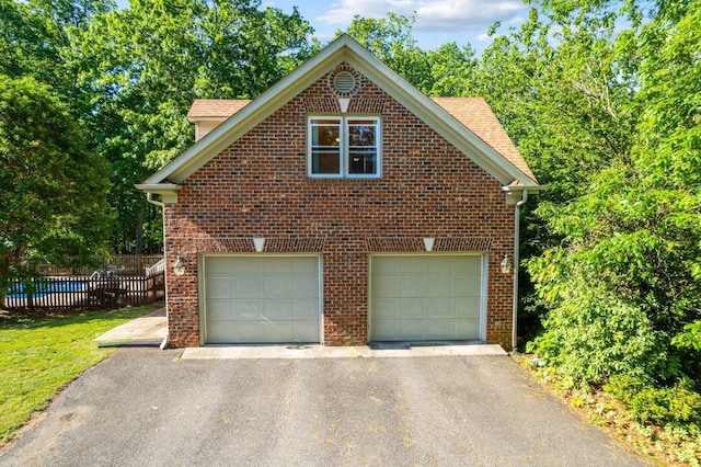 1068 Huckleberry Ln, Lynchburg, VA 24503 - view of side of property with asphalt driveway, an attached garage, and brick siding