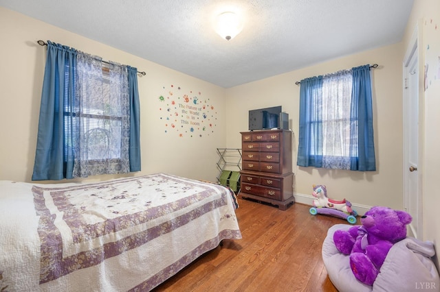 500 Leftwich St, Gretna, VA 24557 - bedroom featuring wood finished floors, a textured ceiling, and baseboards