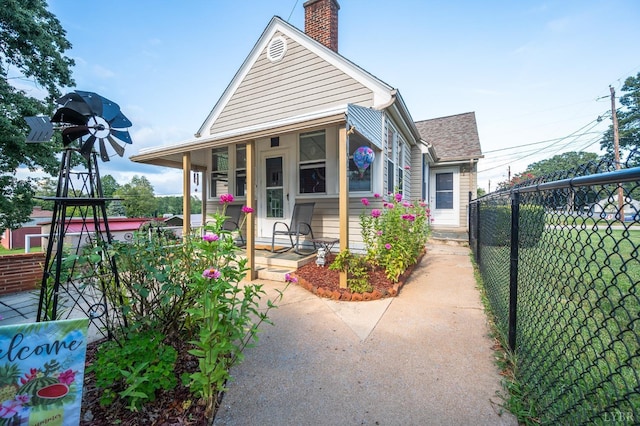 500 Leftwich St, Gretna, VA 24557 - view of front of home featuring fence, a chimney, and a porch