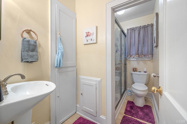 500 Leftwich St, Gretna, VA 24557 - bathroom featuring tile patterned floors, a stall shower, a sink, and toilet