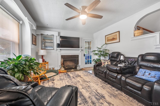 500 Leftwich St, Gretna, VA 24557 - living area featuring ceiling fan, a fireplace, plenty of natural light, wood finished floors, and a textured ceiling