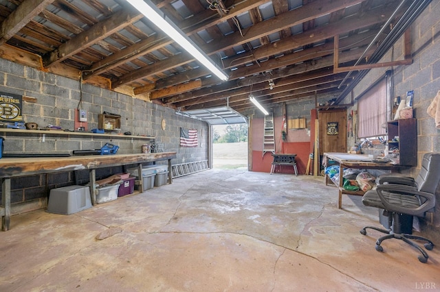 500 Leftwich St, Gretna, VA 24557 - miscellaneous room featuring concrete block wall, a workshop area, unfinished concrete flooring, and a garage