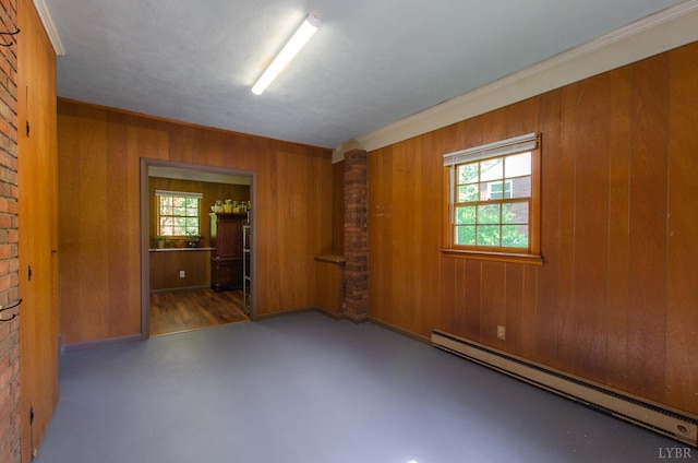 1426 Nelson Dr, Lynchburg, VA 24502 - spare room featuring baseboard heating, healthy amount of natural light, wood walls, decorative columns, and crown molding