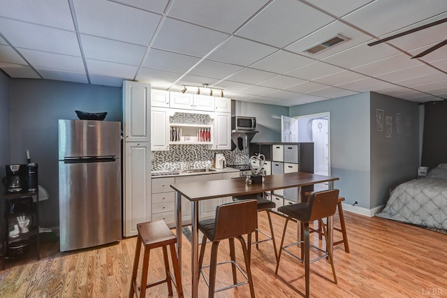 206 Bella Ct, Lynchburg, VA 24502 - kitchen with stainless steel appliances, a paneled ceiling, light wood-type flooring, a sink, and white cabinets