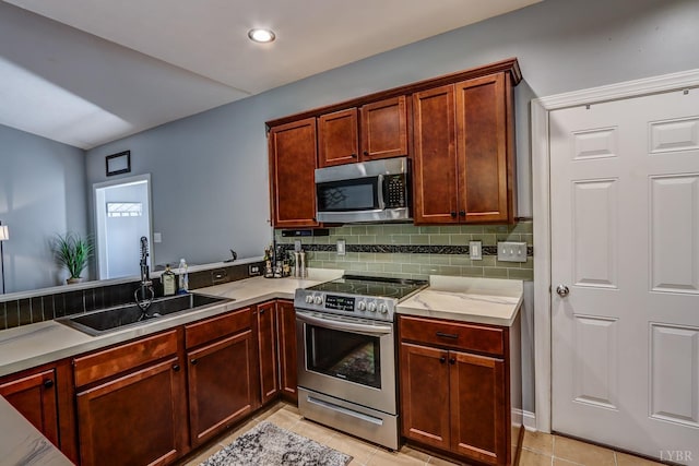 206 Bella Ct, Lynchburg, VA 24502 - kitchen featuring appliances with stainless steel finishes, a sink, light tile patterned flooring, backsplash, and light countertops