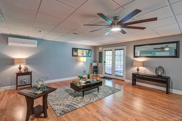 206 Bella Ct, Lynchburg, VA 24502 - living room featuring an AC wall unit, a ceiling fan, wood finished floors, and baseboards
