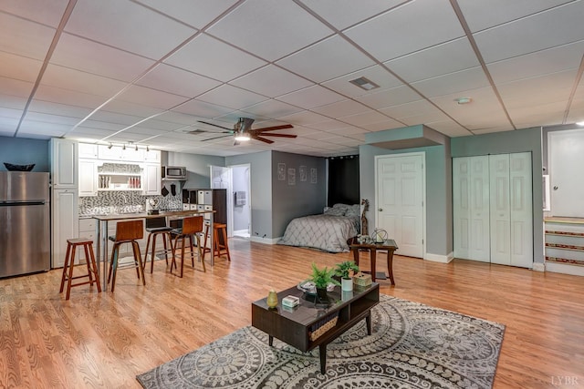 206 Bella Ct, Lynchburg, VA 24502 - living room with light wood-style flooring, a ceiling fan, baseboards, and a paneled ceiling