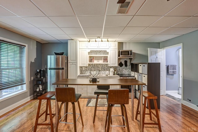 206 Bella Ct, Lynchburg, VA 24502 - dining area featuring a drop ceiling, light wood-type flooring, and baseboards