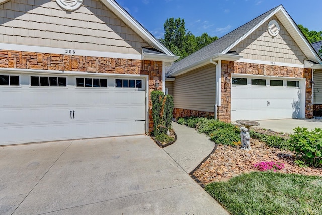 206 Bella Ct, Lynchburg, VA 24502 - view of side of property featuring stone siding, an outbuilding, and driveway