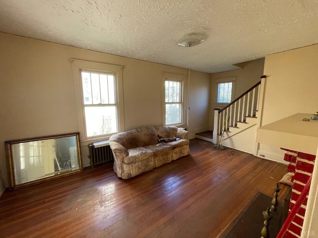 1706 Floyd St, Lynchburg, VA 24501 - living area featuring radiator heating unit, wood finished floors, a textured ceiling, and stairs