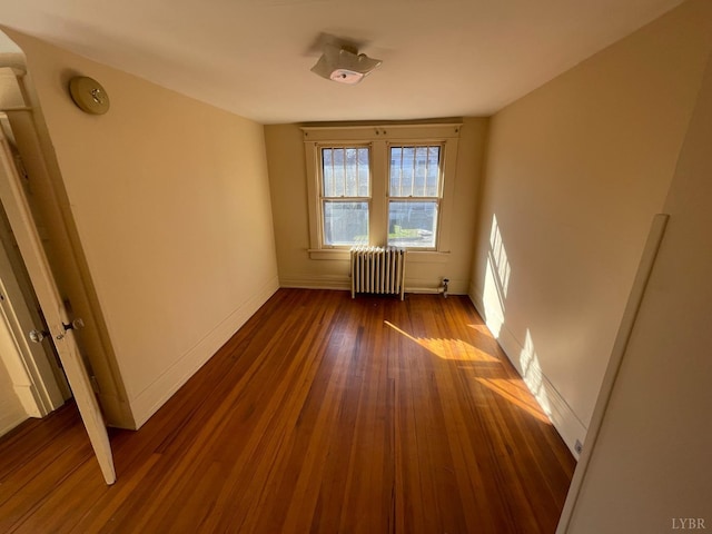 1706 Floyd St, Lynchburg, VA 24501 - empty room featuring radiator, dark wood-type flooring, baseboards, and a smoke detector