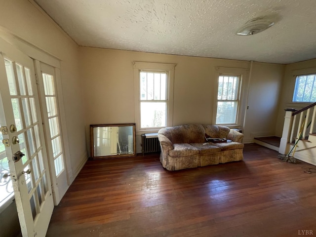 1706 Floyd St, Lynchburg, VA 24501 - living area featuring wood finished floors, a textured ceiling, radiator, and stairway