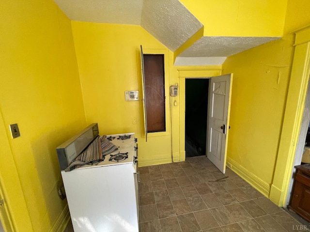 1706 Floyd St, Lynchburg, VA 24501 - kitchen featuring white range with gas cooktop, a textured ceiling, and baseboards