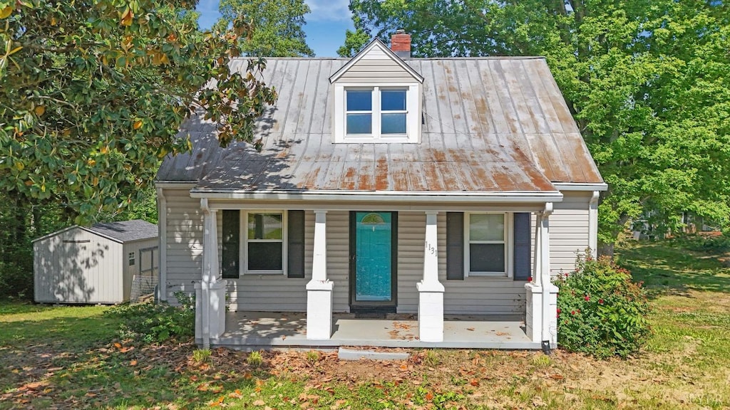 1131 Tabor Rd, Gladys, VA 24554 - view of front of home featuring a chimney, a porch, metal roof, and a standing seam roof