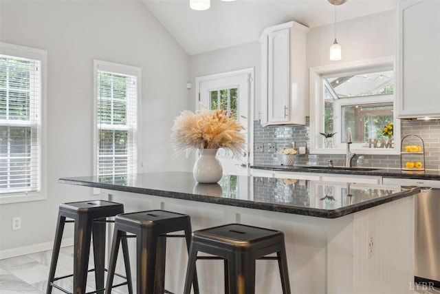112 Cedarwood Ct, Forest, VA 24551 - kitchen featuring a sink, stainless steel dishwasher, tasteful backsplash, lofted ceiling, and white cabinets