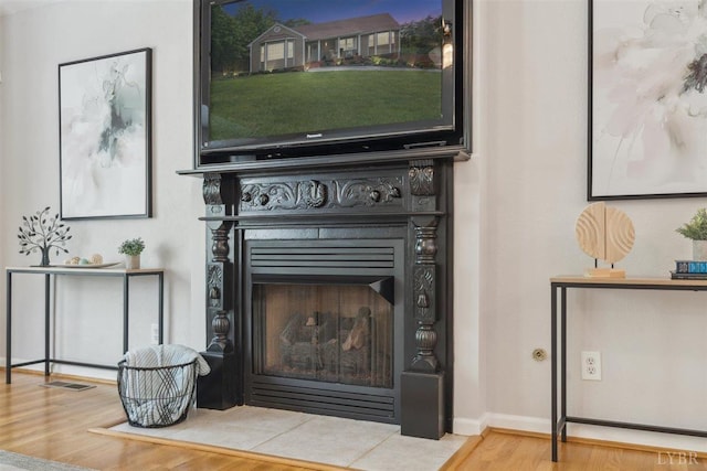 112 Cedarwood Ct, Forest, VA 24551 - detailed view of wood finished floors, a fireplace with flush hearth, and baseboards