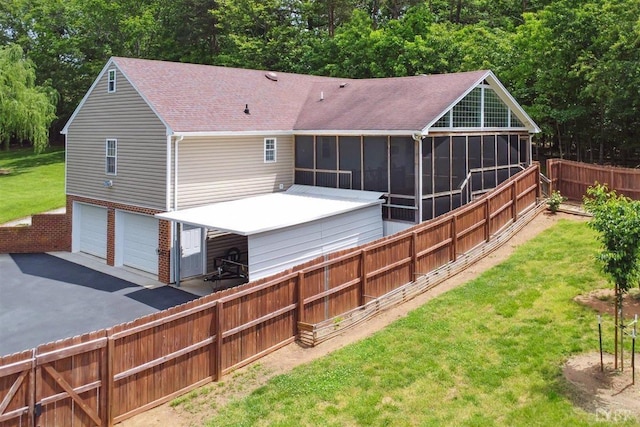 112 Cedarwood Ct, Forest, VA 24551 - back of property featuring a sunroom, a garage, roof with shingles, and asphalt driveway