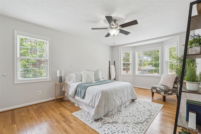 112 Cedarwood Ct, Forest, VA 24551 - bedroom featuring multiple windows, baseboards, wood finished floors, and a textured ceiling
