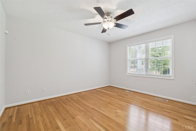 112 Cedarwood Ct, Forest, VA 24551 - unfurnished room featuring light wood-style floors, baseboards, ceiling fan, and a textured ceiling