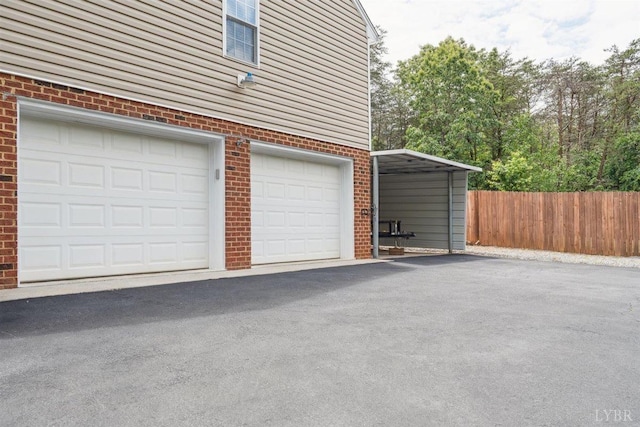 112 Cedarwood Ct, Forest, VA 24551 - garage with driveway and a carport